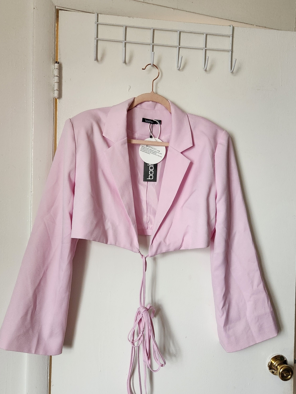 Boohoo baby pink basic woven relaxed fit crop blazer with a tie-front .